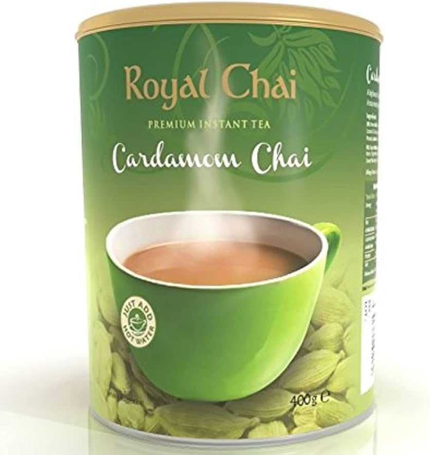 Green can of Royal Chai Cardamom Chai with a cup of tea on a white background